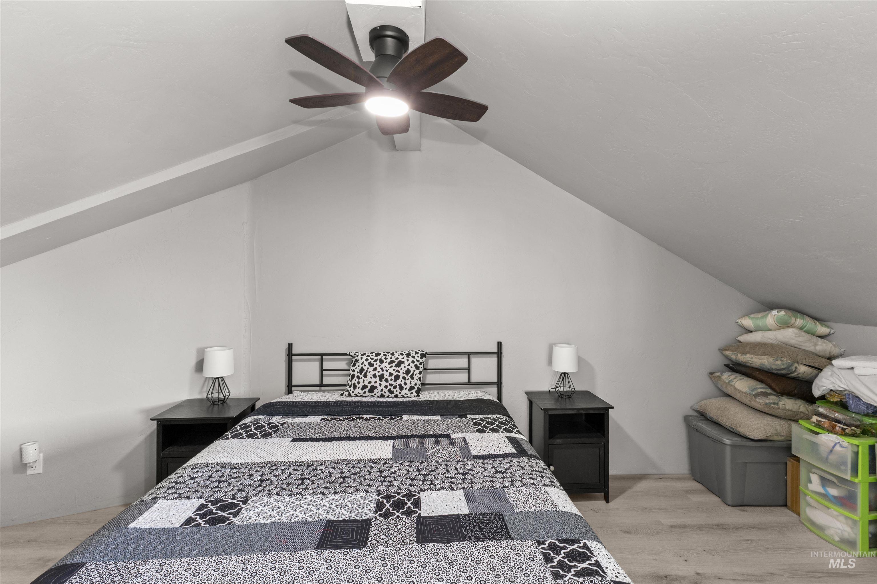 1030 Desert Glen Road Adrian, OR 97901 - Photo 42 of 47 Attic room featuring sloped ceilings, wood-finish flooring, and a ceiling fan with integrated lighting
