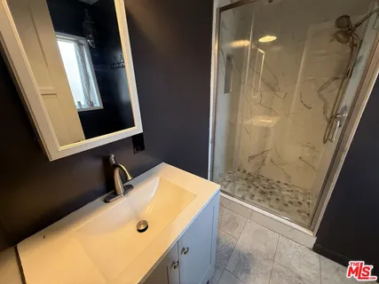 a bathroom with a tub sink and shower