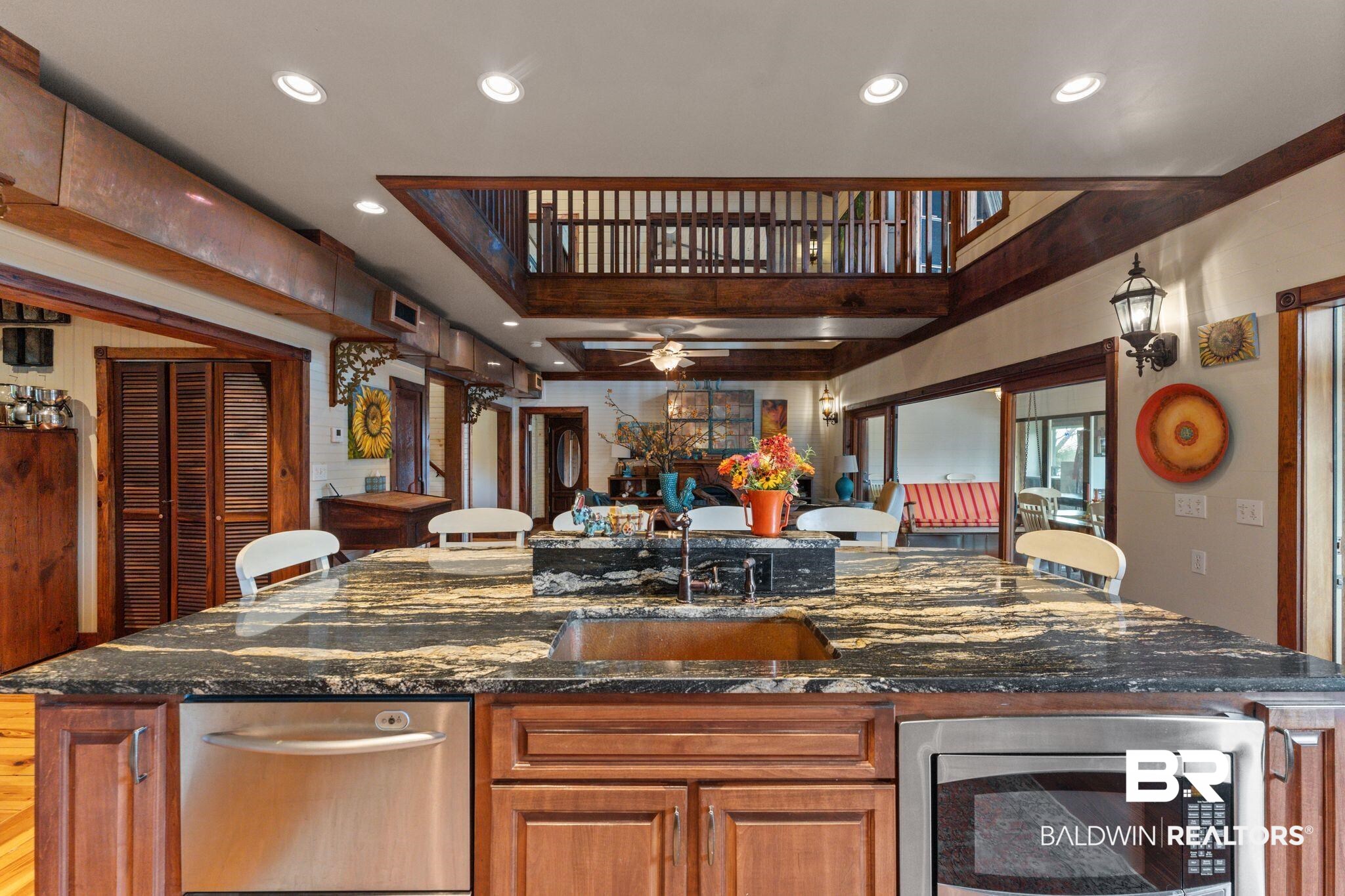 16451 Honey Road Summerdale, AL 36580 - Photo 9 of 55 Kitchen featuring brown cabinetry, dark stone countertops, recessed lighting, appliances with stainless steel finishes, and an island with sink
