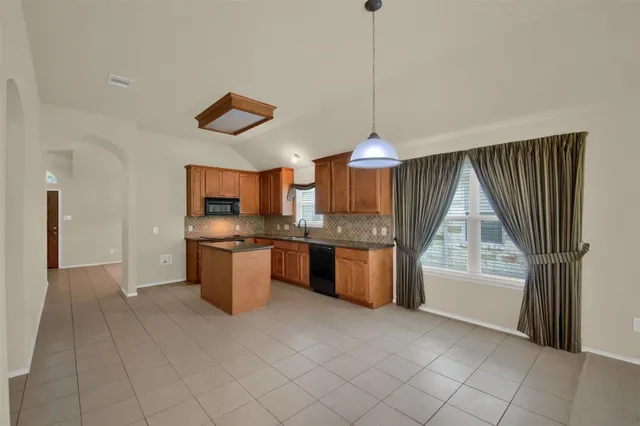 a kitchen with a stove a refrigerator and a sink