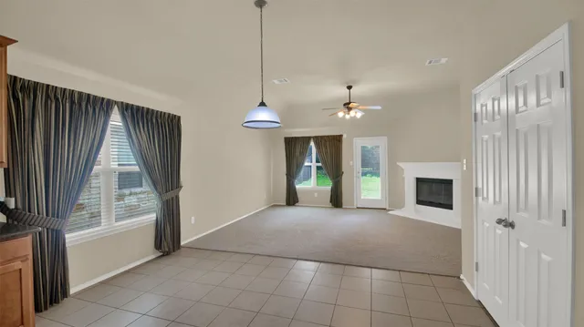 a view of a livingroom with an empty space and a fireplace