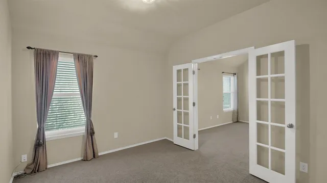 a view of a big room with chandelier fan and closet area