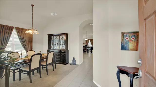 a view of a dining room with furniture and window