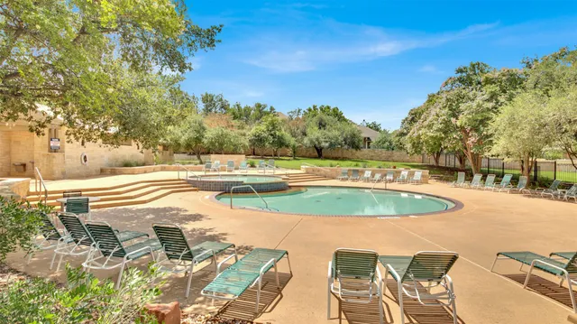 a sign of golf club on a wall under a tree