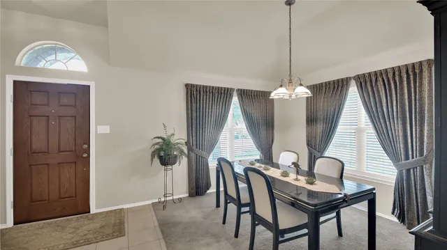 a view of a workspace with furniture and window