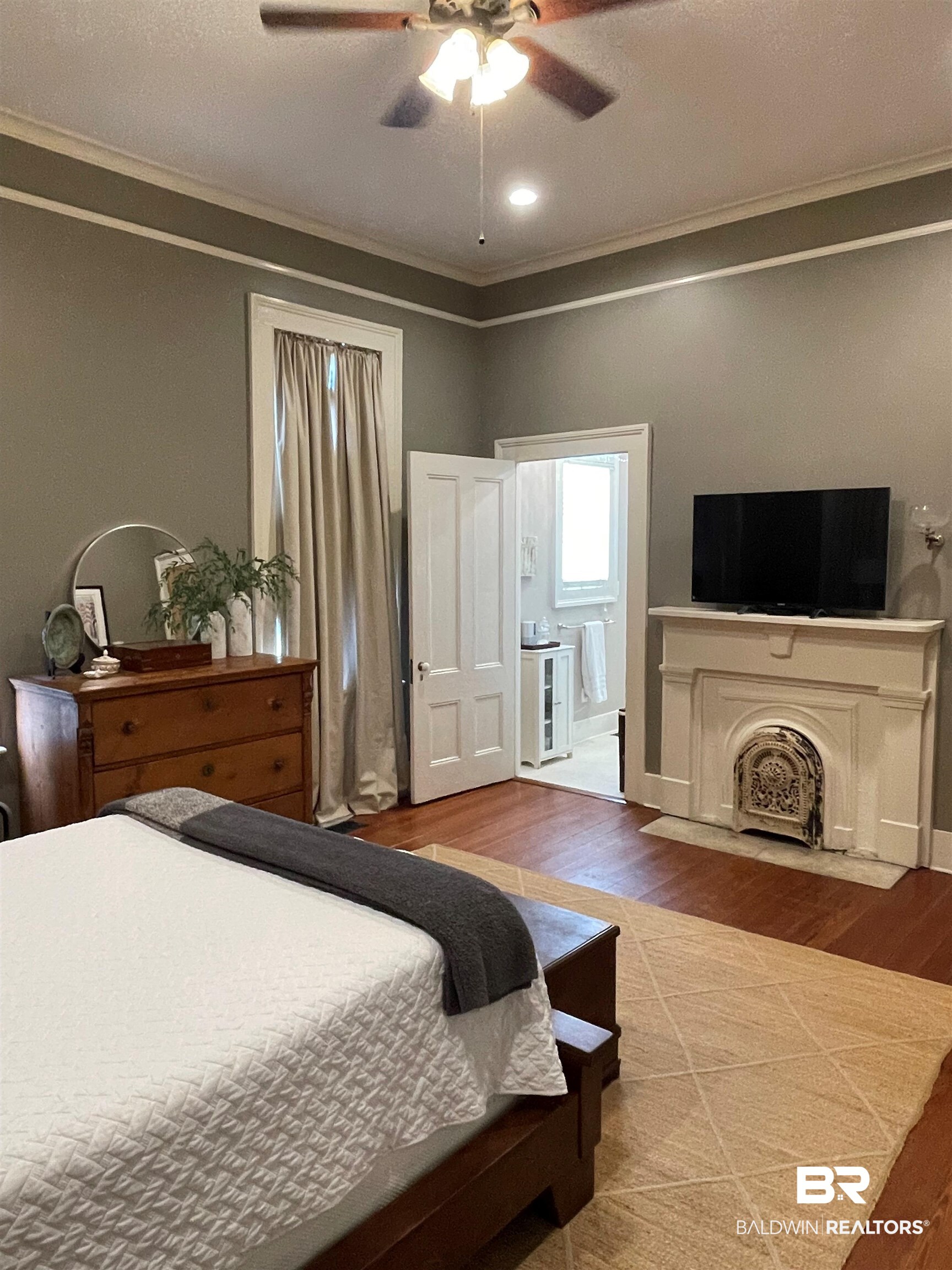 1001 Augusta Street Mobile, AL 36604 - Photo 24 of 26 Bedroom with ornamental molding, hardwood / wood-style flooring, connected bathroom, and ceiling fan