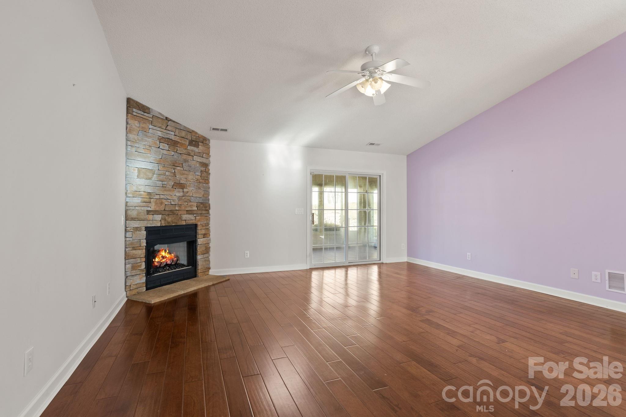 32 Stone House Road Hendersonville, NC 28739 - Photo 11 of 31 a view of an empty room with wooden floor fireplace and a window