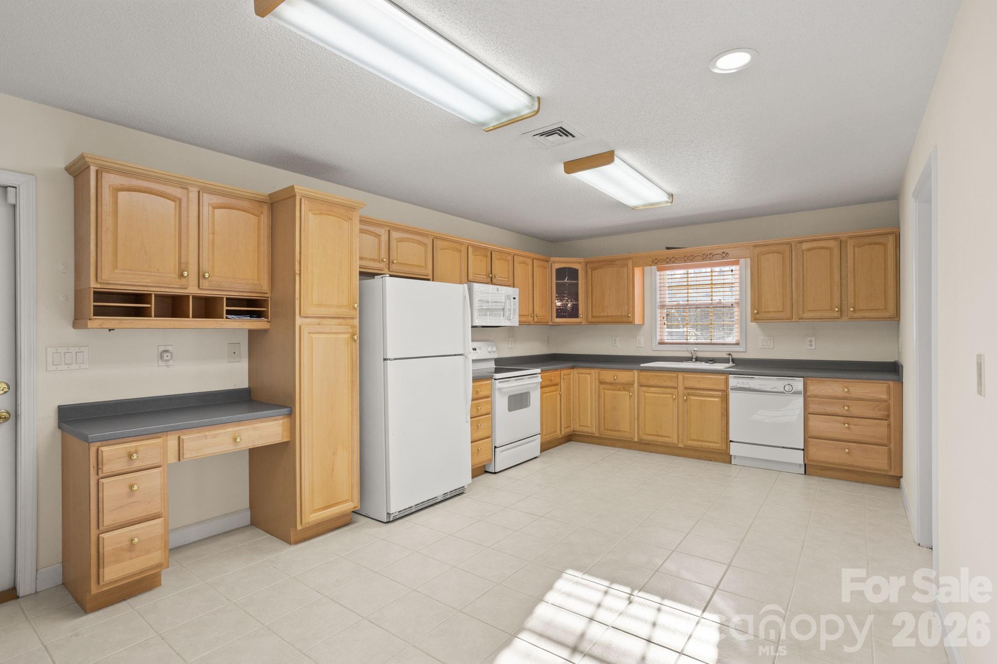 32 Stone House Road Hendersonville, NC 28739 - Photo 17 of 31 a kitchen with a refrigerator sink and cabinets