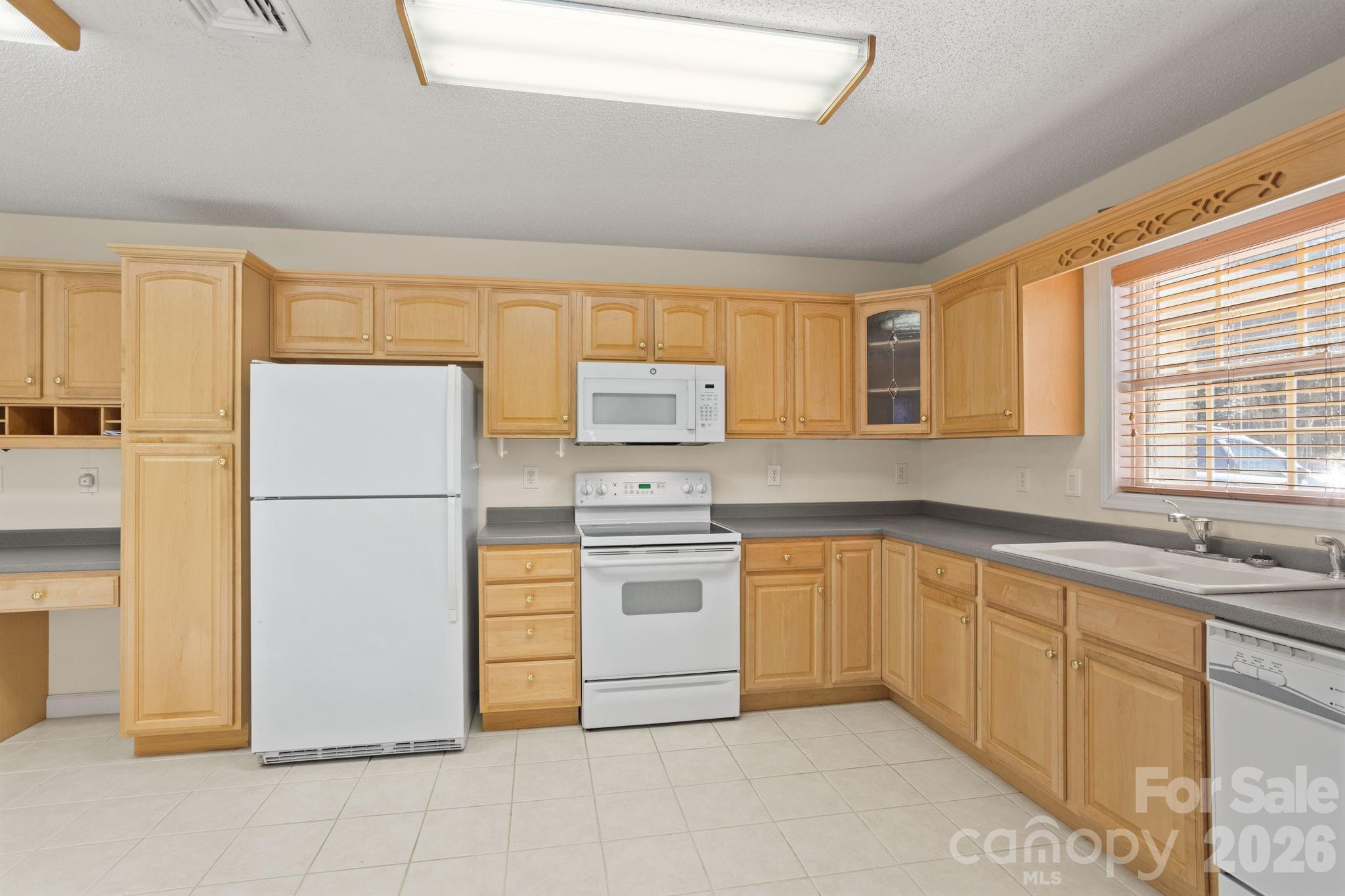 32 Stone House Road Hendersonville, NC 28739 - Photo 18 of 31 a kitchen with stainless steel appliances granite countertop a refrigerator sink and cabinets