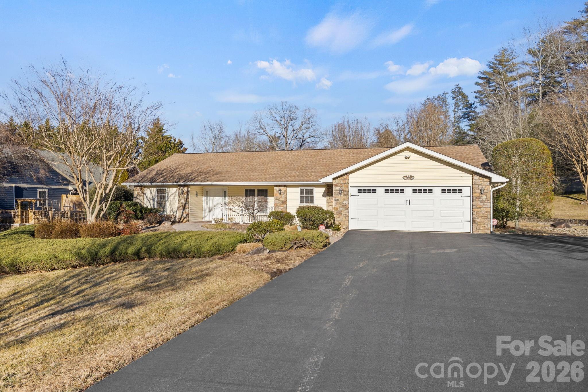 32 Stone House Road Hendersonville, NC 28739 - Photo 2 of 31 a view of a white house with a yard and large trees