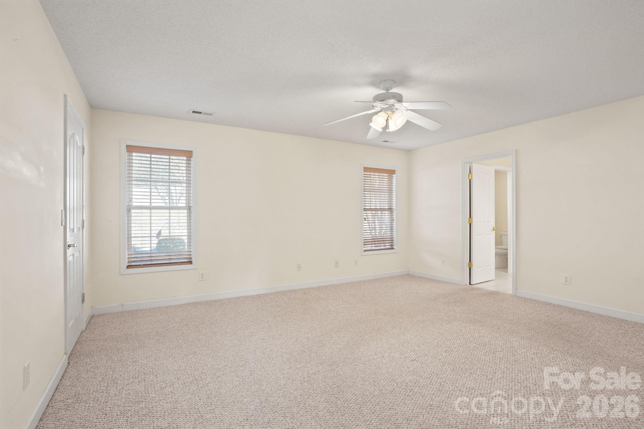 32 Stone House Road Hendersonville, NC 28739 - Photo 21 of 31 an empty room with chandelier fan and windows