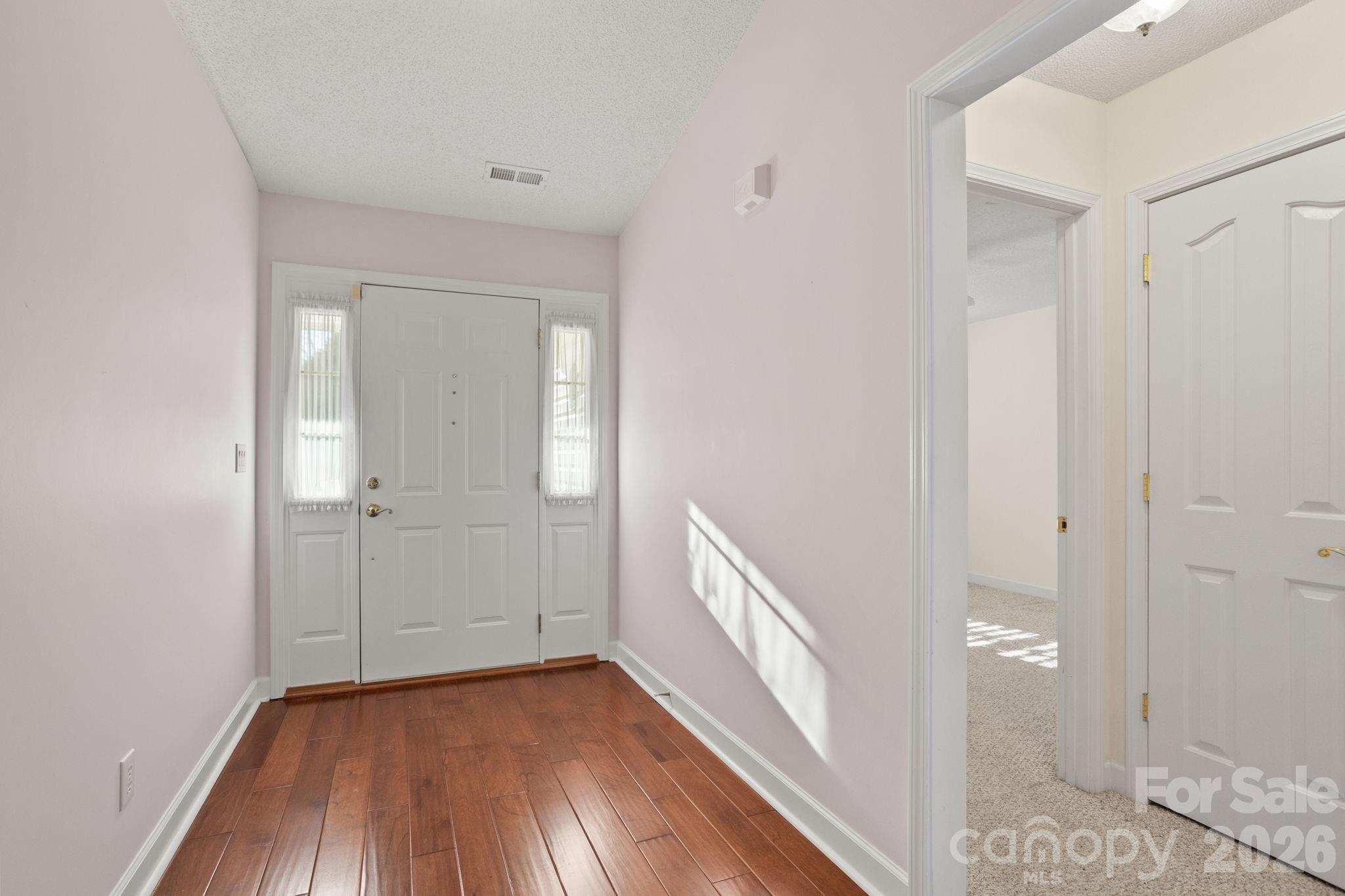32 Stone House Road Hendersonville, NC 28739 - Photo 5 of 31 a view of a hallway with wooden floor and a bathroom