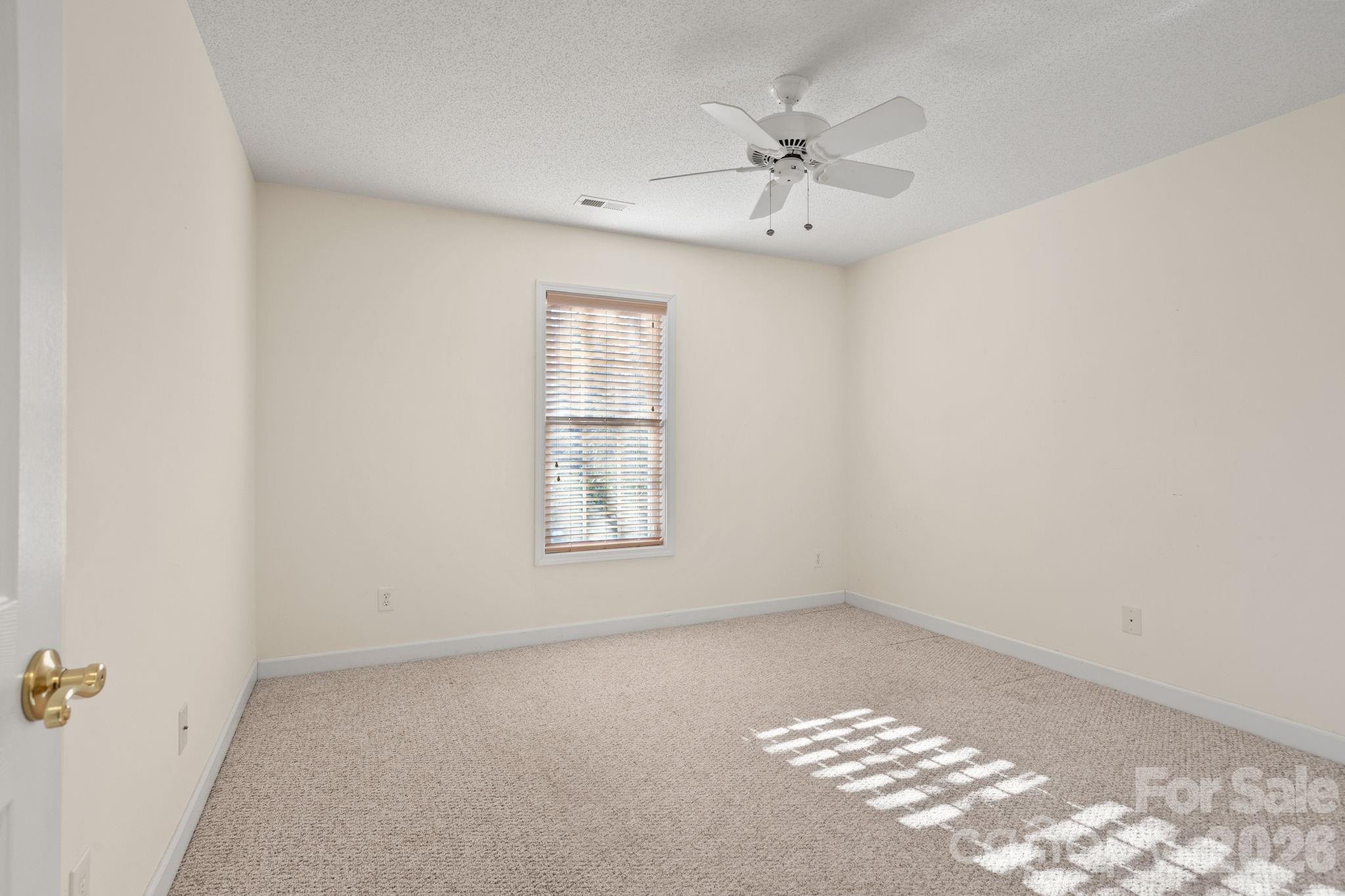 32 Stone House Road Hendersonville, NC 28739 - Photo 6 of 31 an empty room with windows and fan