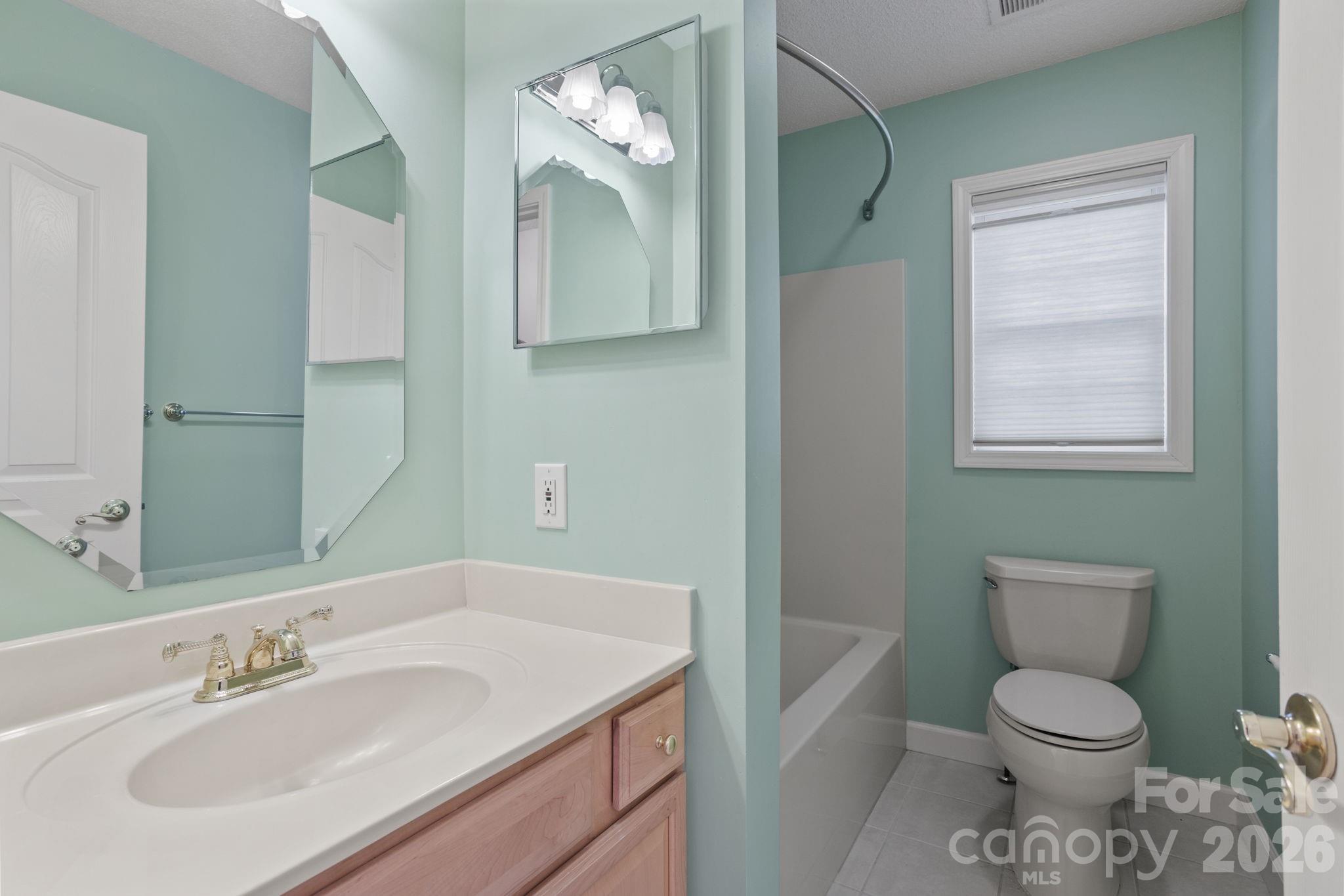 32 Stone House Road Hendersonville, NC 28739 - Photo 8 of 31 a bathroom with a toilet sink and mirror