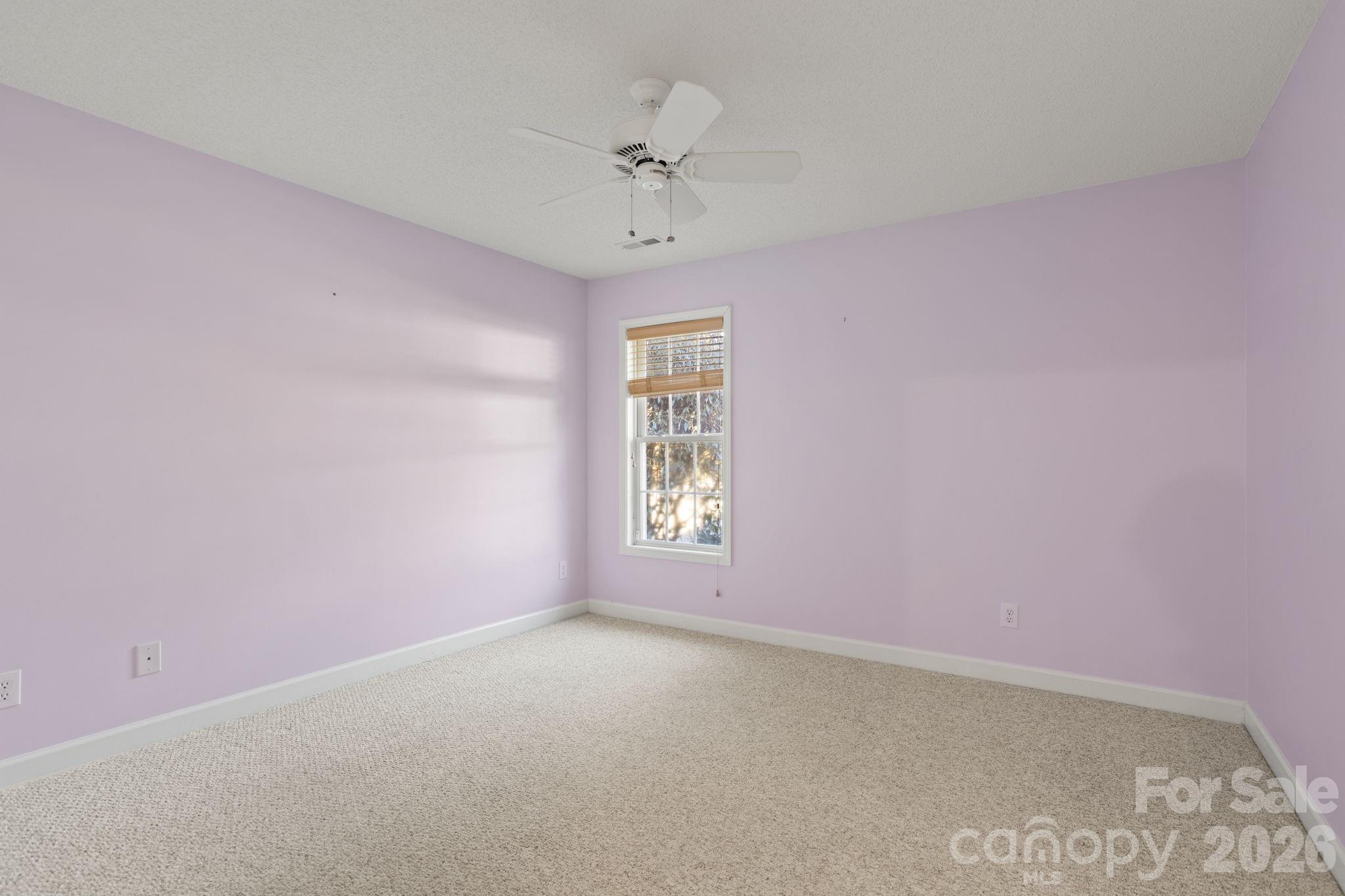 32 Stone House Road Hendersonville, NC 28739 - Photo 9 of 31 an empty room with a window and a ceiling fan