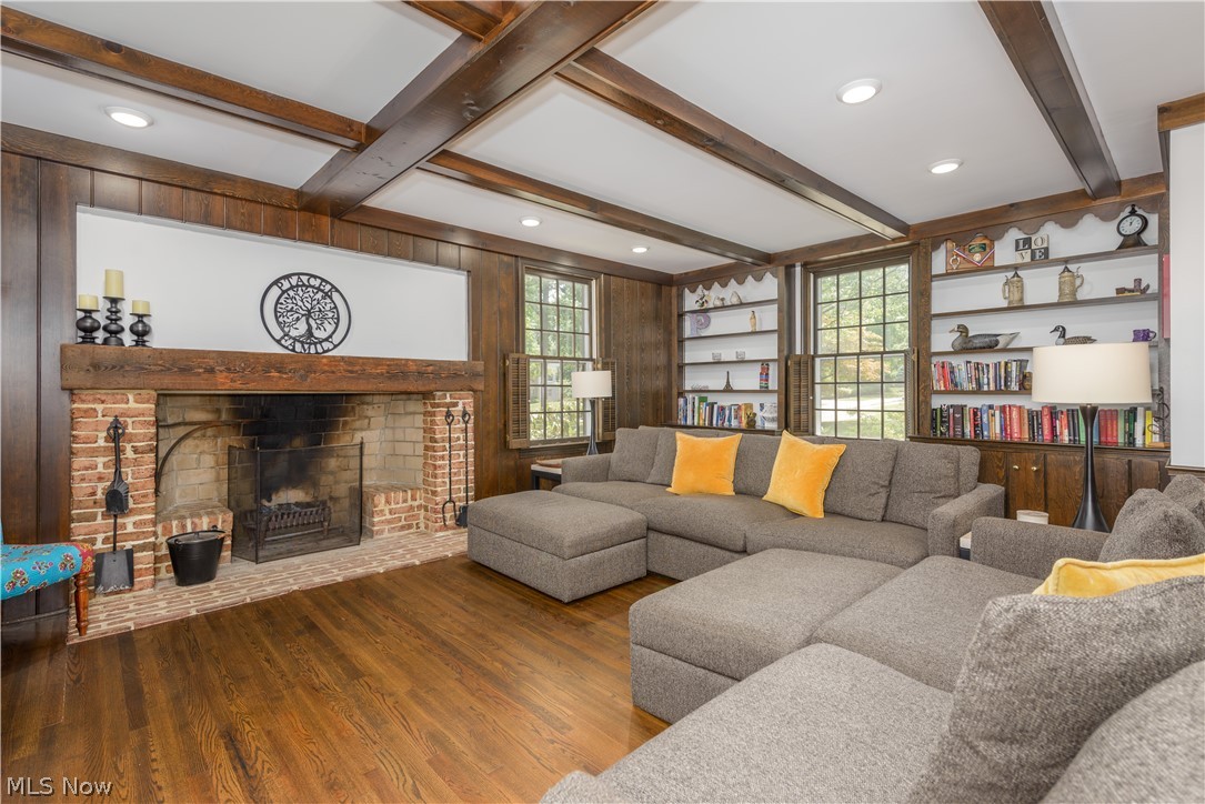 2447 Covington Road Akron, OH 44313 - Photo 21 of 46 Great room with beamed ceiling, the large hearth fireplace, wall of built-in bookshelves and gorgeous hardwood floors