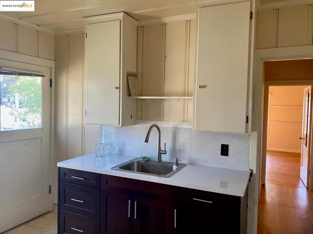 a kitchen with a sink and cabinets