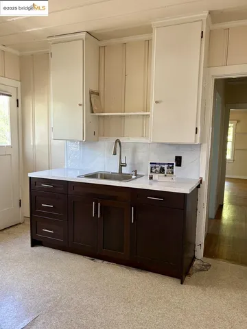 a view of a room with wooden floor and window