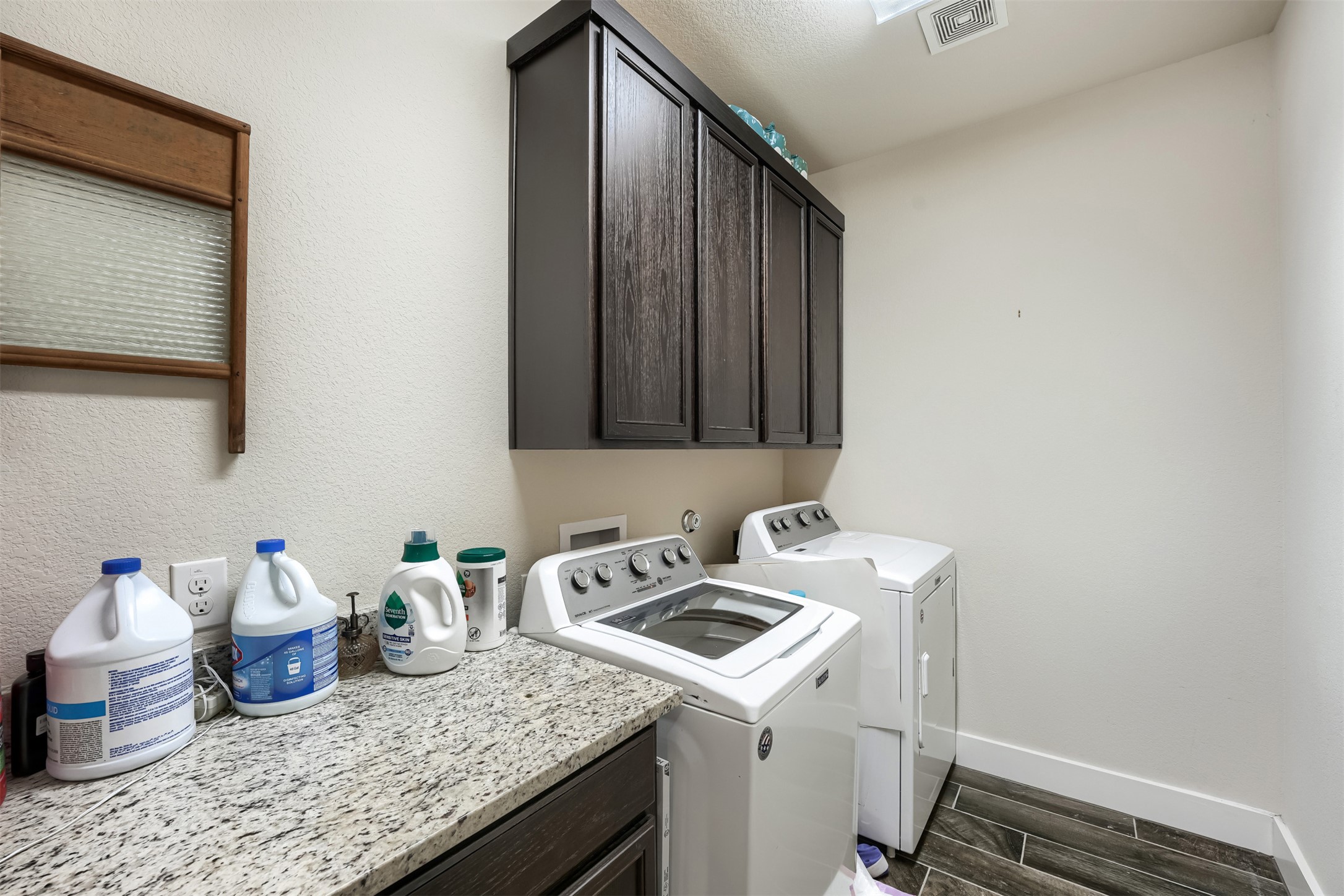 418 High Tech Drive Georgetown, TX 78626 - Photo 23 of 34 Dedicated laundry area featuring granite-look countertops and dark wood-finish cabinetry