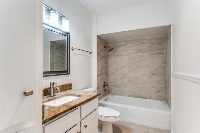 en empty room with windows and chandelier fan