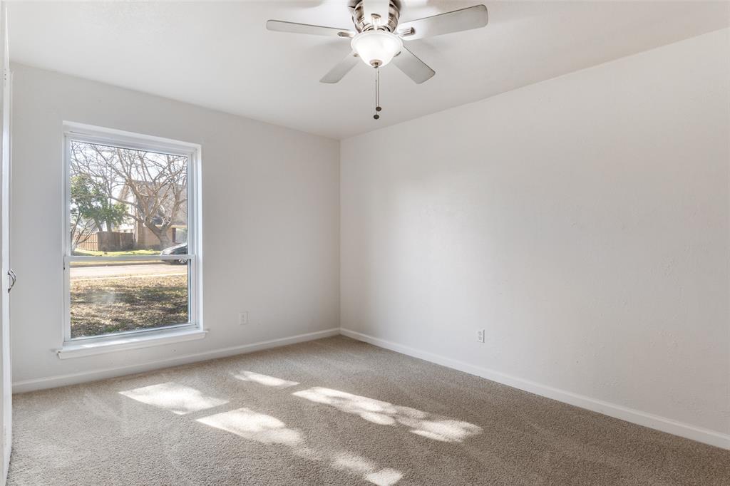 2805 Raintree Drive Plano, TX 75074 - Photo 8 of 12 en empty room with windows and chandelier fan