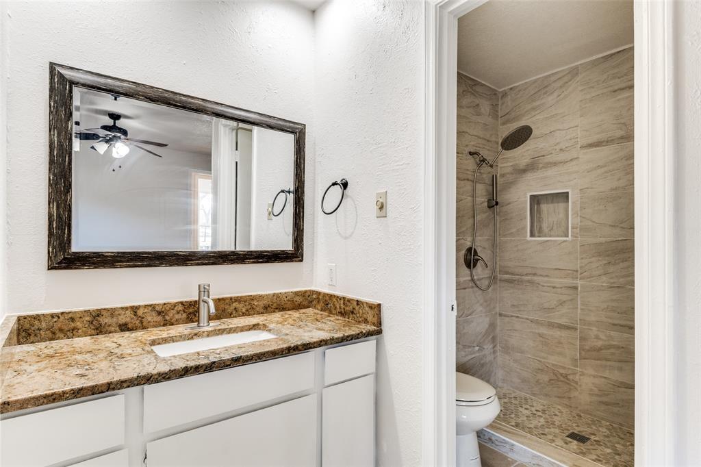2805 Raintree Drive Plano, TX 75074 - Photo 10 of 12 a bathroom with a granite countertop sink toilet and shower