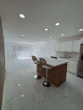 a kitchen with kitchen island cabinets and window