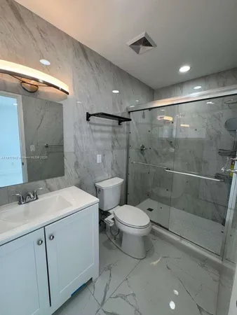a bathroom with a sink toilet and shower