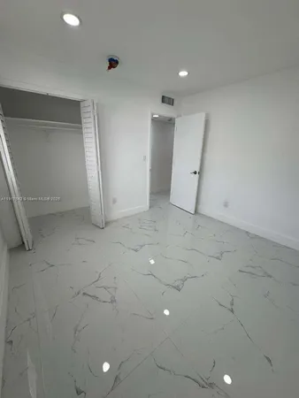 an empty room with white walls and tiles