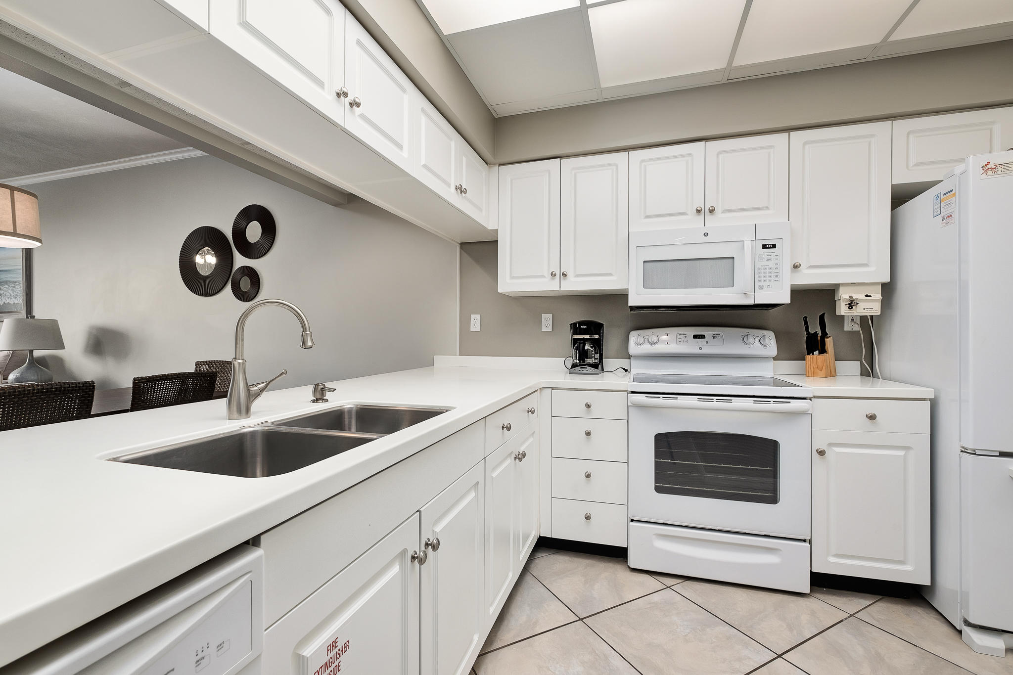 10254 East County Highway, Unit 312 Inlet Beach, FL 32461 - Photo 15 of 36 a kitchen with white cabinets and white appliances