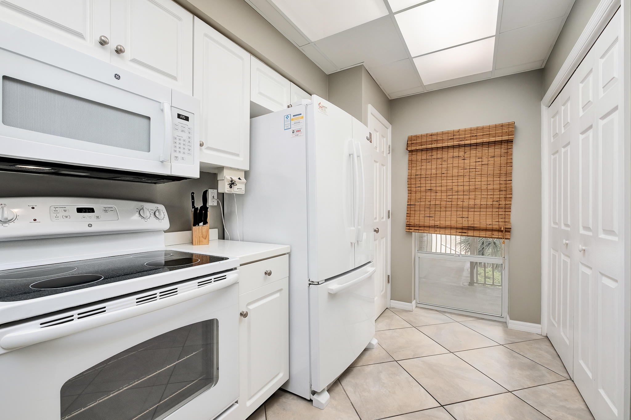 10254 East County Highway, Unit 312 Inlet Beach, FL 32461 - Photo 16 of 36 a kitchen with white cabinets and white appliances