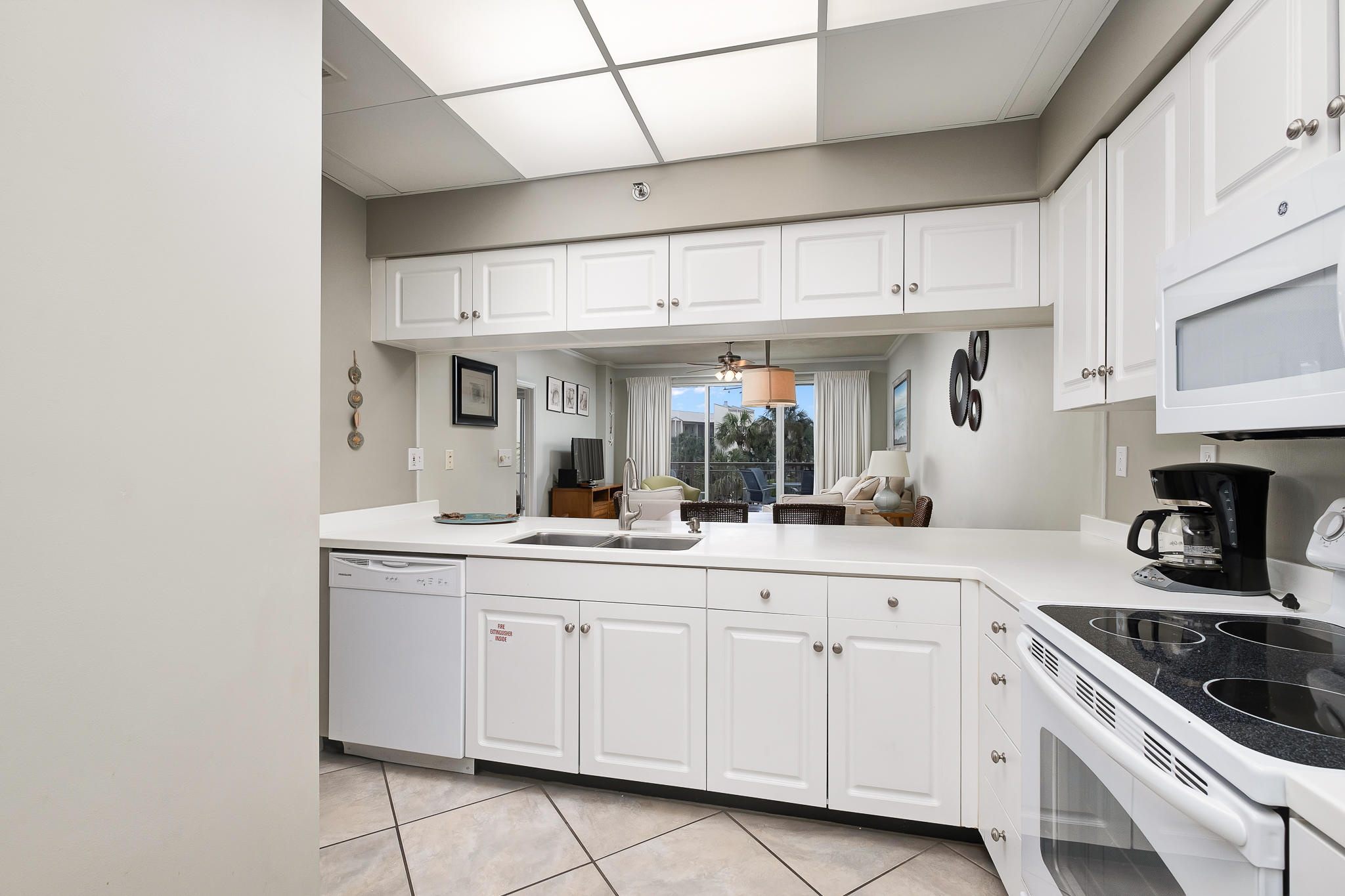 10254 East County Highway, Unit 312 Inlet Beach, FL 32461 - Photo 17 of 36 a kitchen with white cabinets and appliances