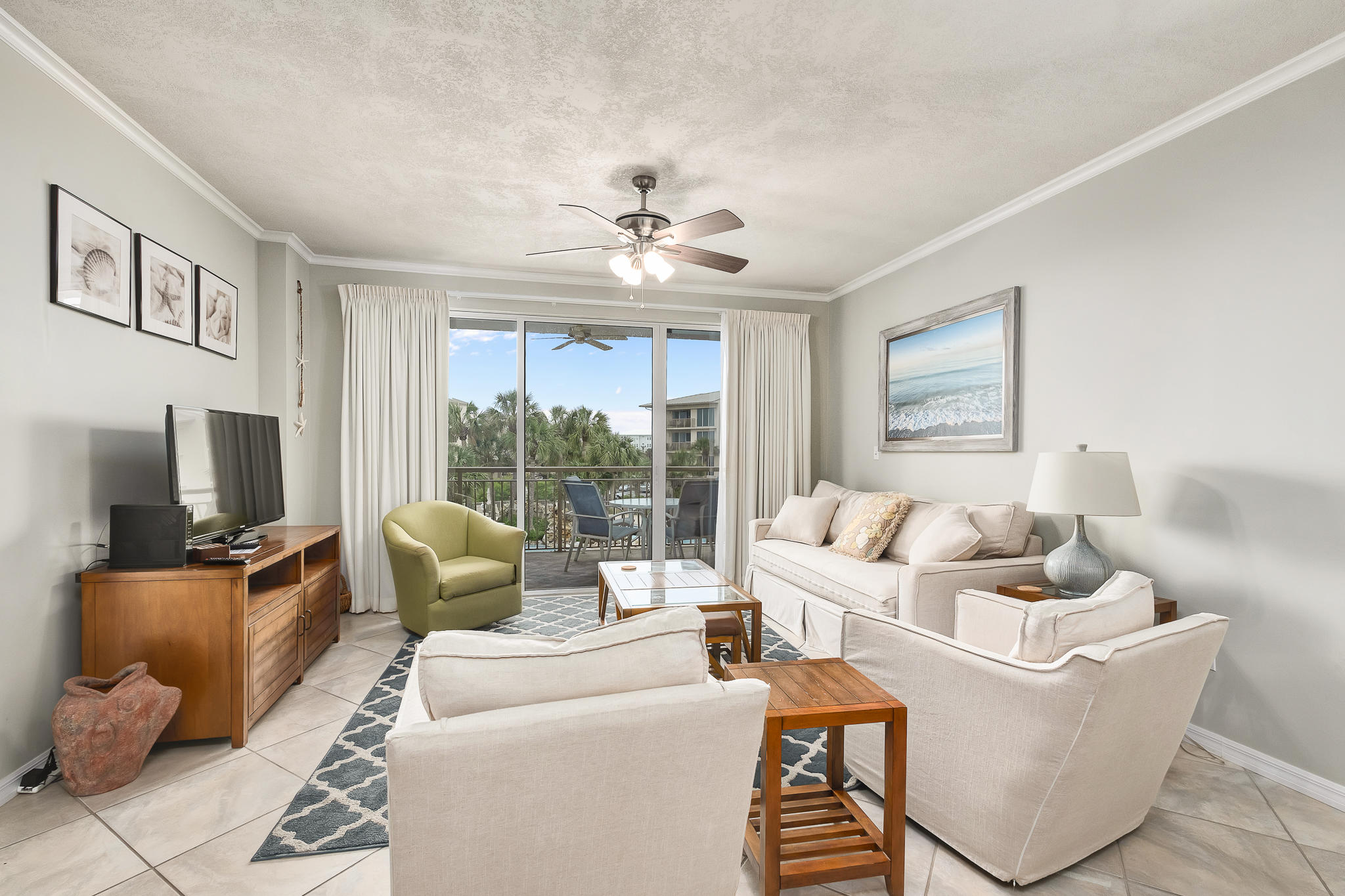 10254 East County Highway, Unit 312 Inlet Beach, FL 32461 - Photo 4 of 36 a living room with furniture a large window and a flat screen tv