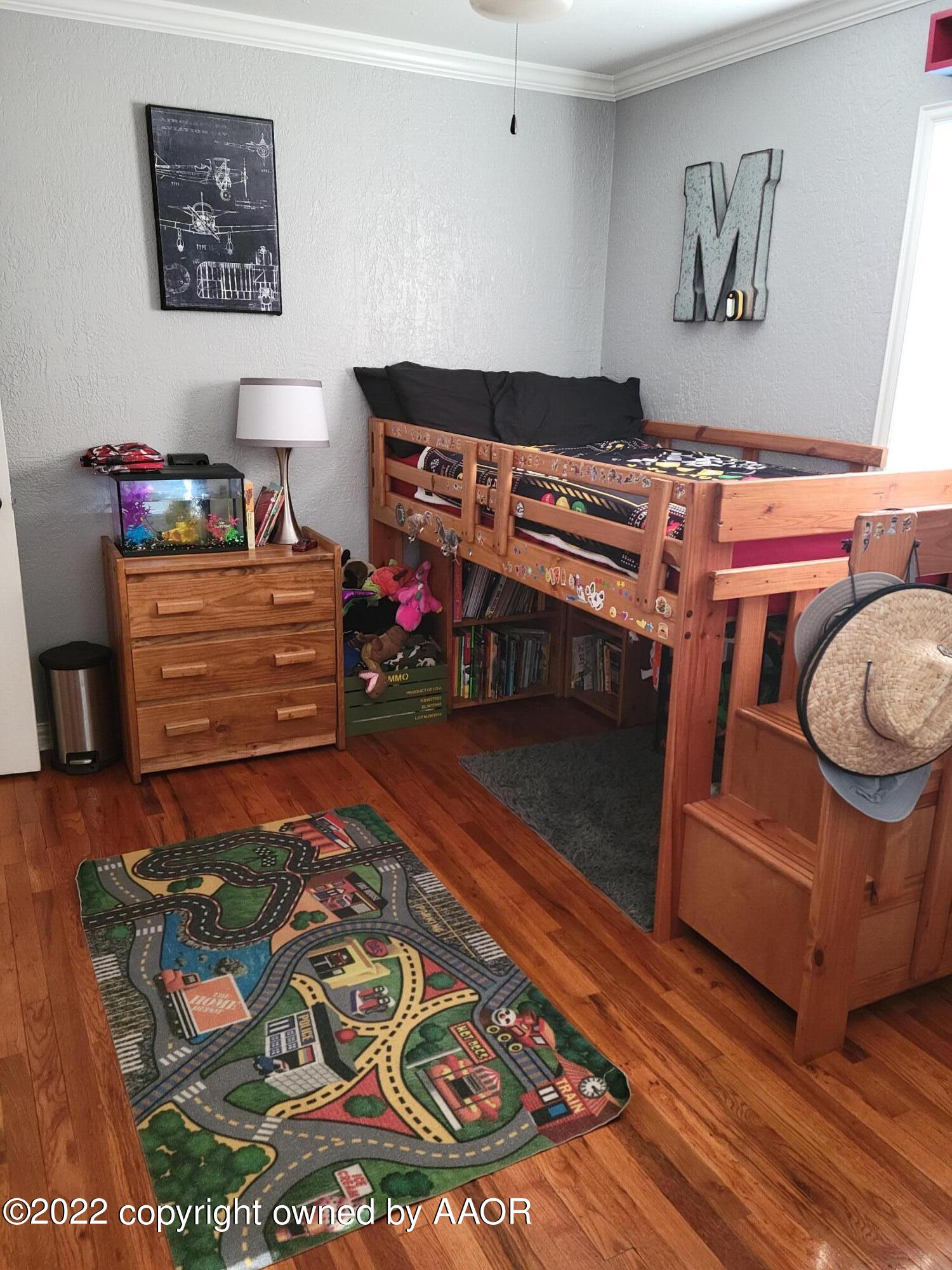 4434 South Travis Street Amarillo, TX 79110 - Photo 4 of 14 a room with furniture and a baby crib