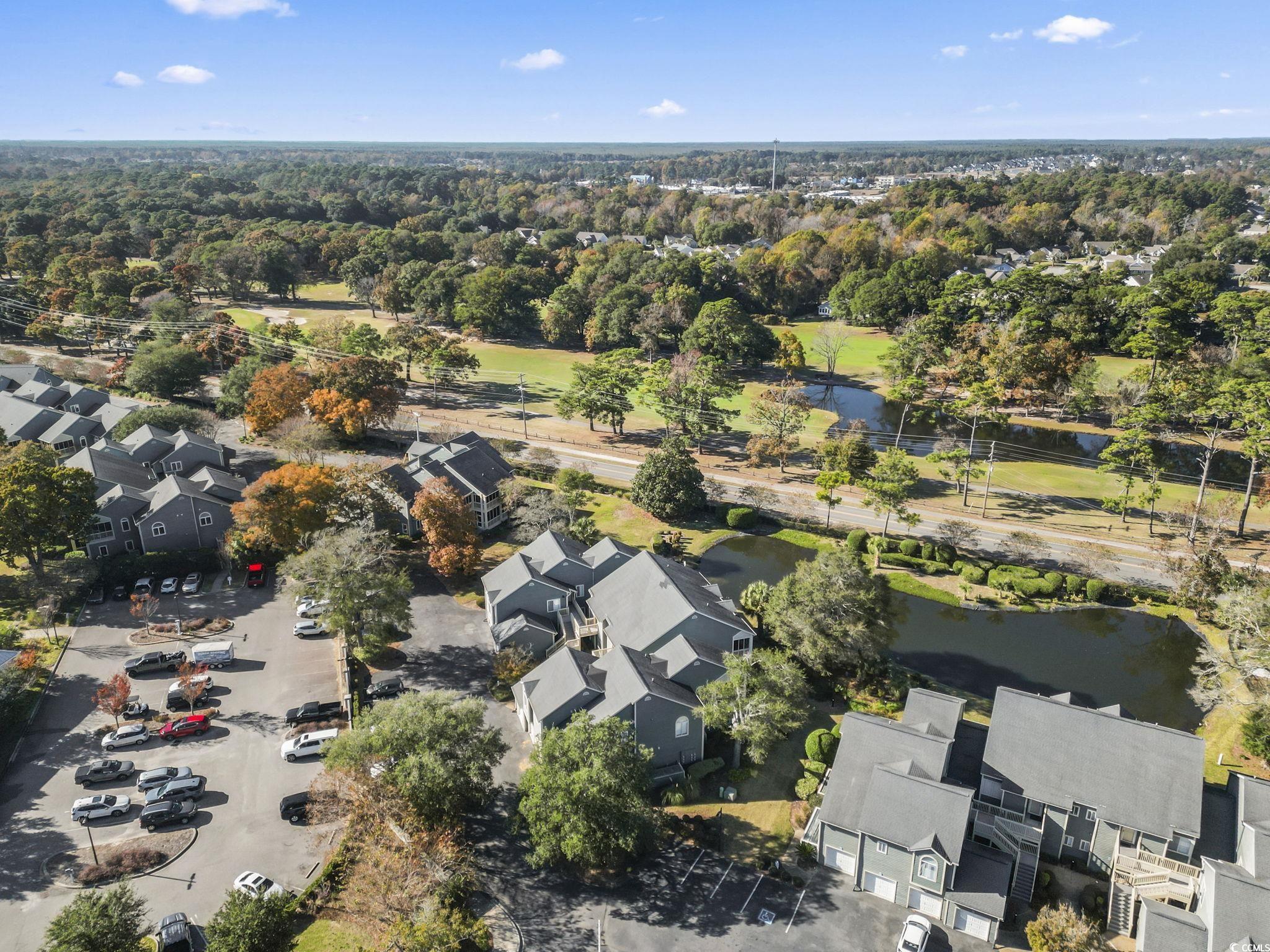 104 High Circle, Unit 8C Myrtle Beach, SC 29572 - Photo 11 of 36 Aerial view of property and surrounding area featuring nearby suburban area and a nearby body of water