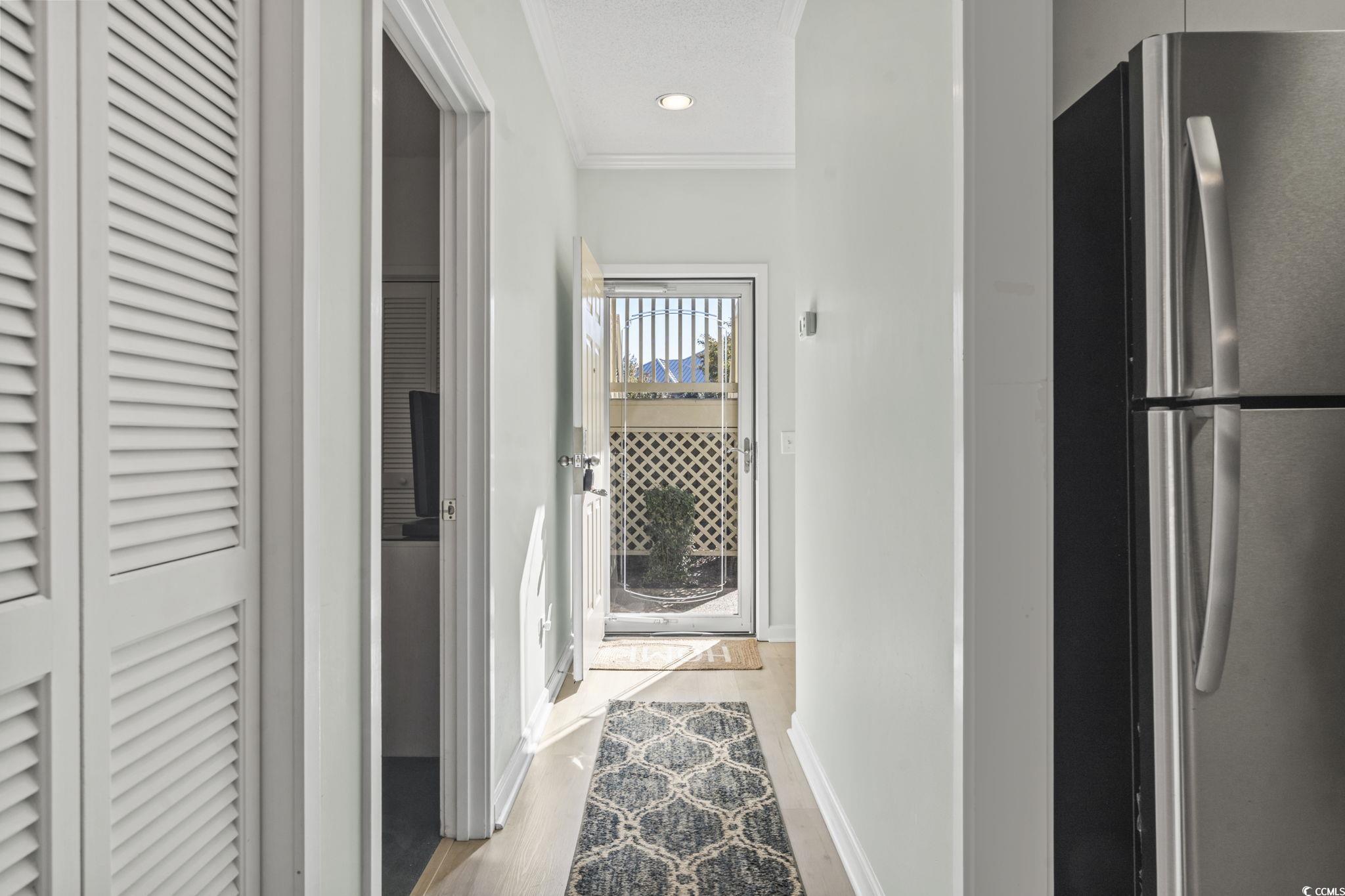 104 High Circle, Unit 8C Myrtle Beach, SC 29572 - Photo 13 of 36 Hallway with crown molding, light wood-style floors, and recessed lighting