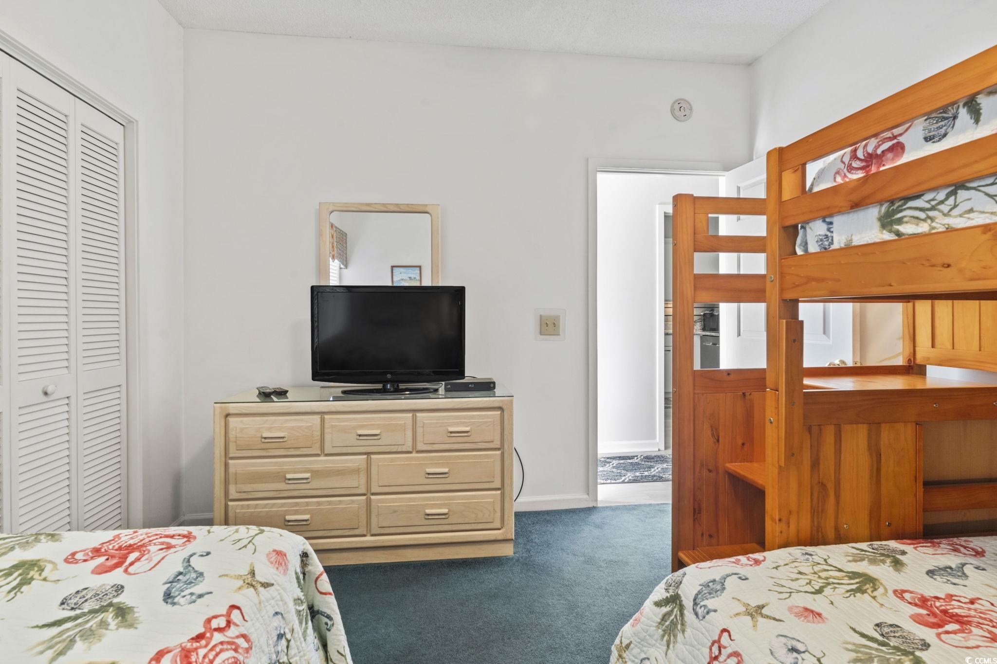 104 High Circle, Unit 8C Myrtle Beach, SC 29572 - Photo 15 of 36 Bedroom with 3 beds, carpet and a closet