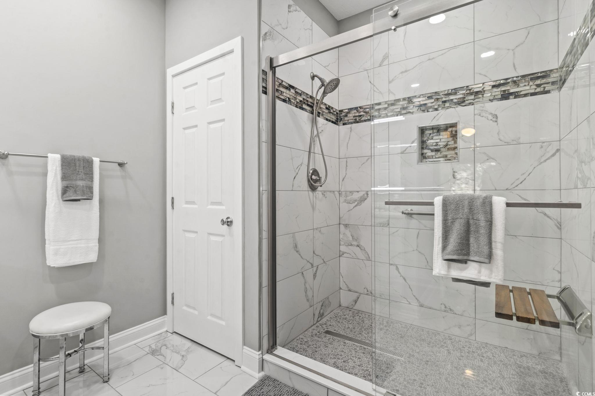 104 High Circle, Unit 8C Myrtle Beach, SC 29572 - Photo 18 of 36 Bathroom featuring marble finish flooring and a marble finish shower