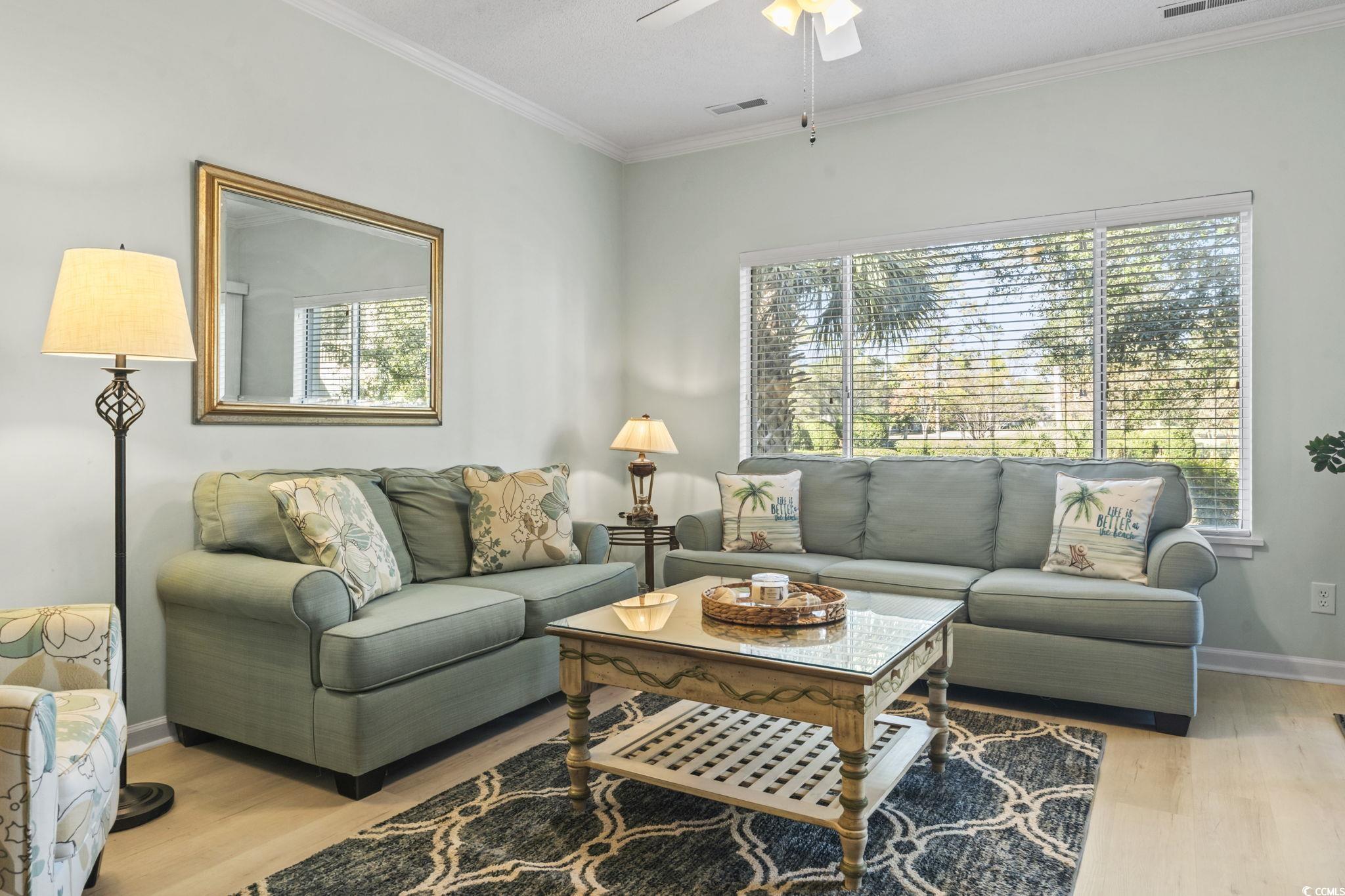 104 High Circle, Unit 8C Myrtle Beach, SC 29572 - Photo 31 of 36 Living room featuring ornamental molding, light wood-type flooring, and ceiling fan