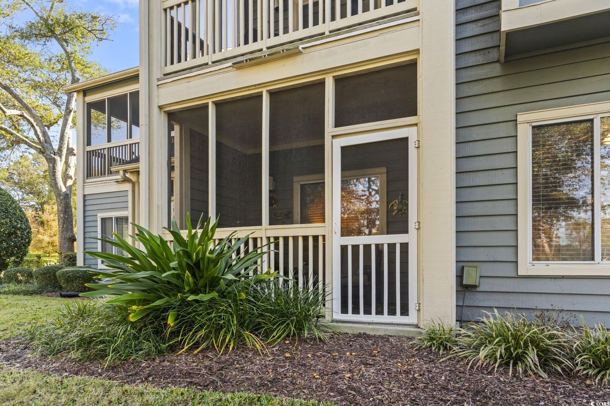 104 High Circle, Unit 8C Myrtle Beach, SC 29572 - Photo 35 of 36 View of the back of the property featuring a sunroom