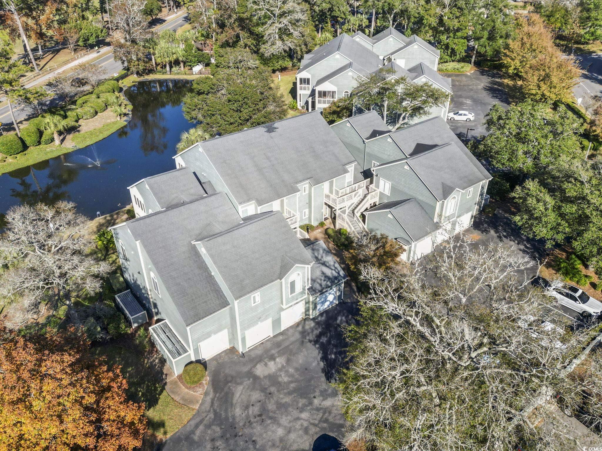 104 High Circle, Unit 8C Myrtle Beach, SC 29572 - Photo 8 of 36 Bird's eye view of a nearby body of water and a tree filled landscape