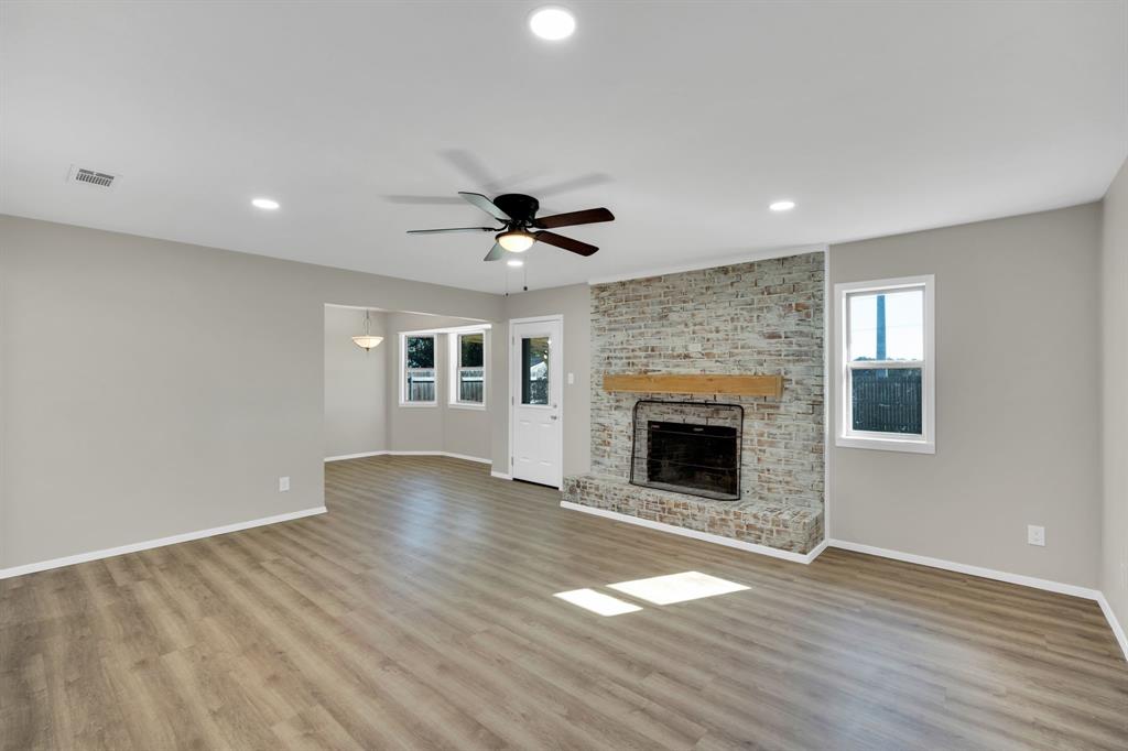 221 North Edgefield Road Waxahachie, TX 75165 - Photo 3 of 27 a view of an empty room with a fireplace and a window