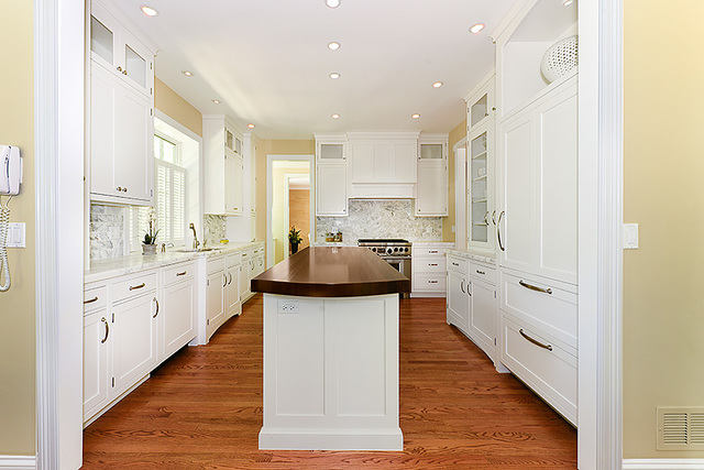 102 Church Road Winnetka, IL 60093 - Photo 19 of 42 a large kitchen with stainless steel appliances lots of counter space and wooden floor