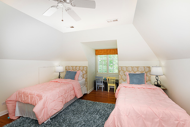 102 Church Road Winnetka, IL 60093 - Photo 32 of 42 a bedroom with a bed and a chandelier