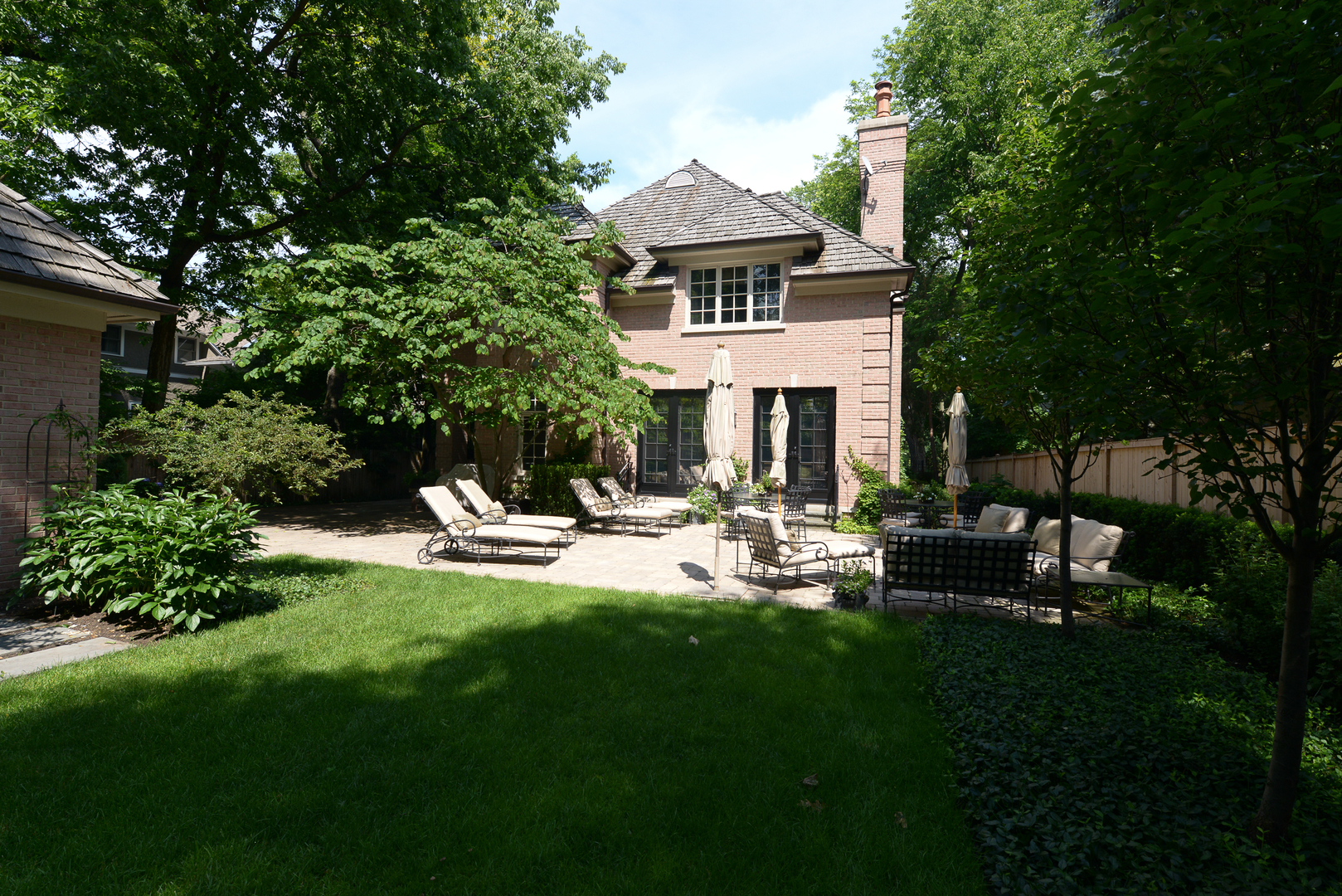 102 Church Road Winnetka, IL 60093 - Photo 40 of 42 a front view of a house with sitting area and garden