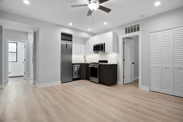 a kitchen with stainless steel appliances granite countertop a refrigerator and a sink