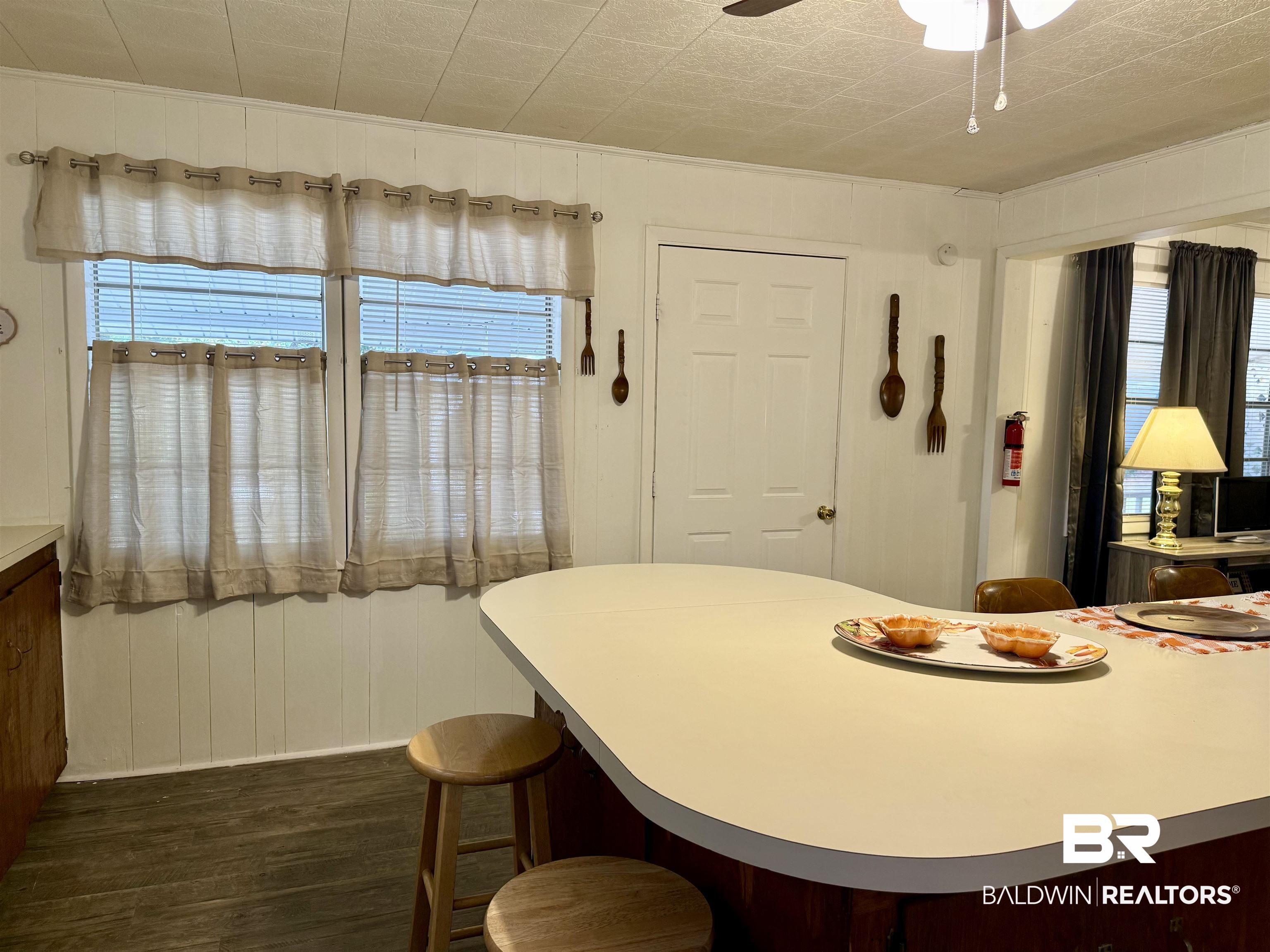 826 West Side Road Castleberry, AL 36432 - Photo 7 of 34 Dining space with wood walls, dark wood-type flooring, healthy amount of natural light, and ceiling fan