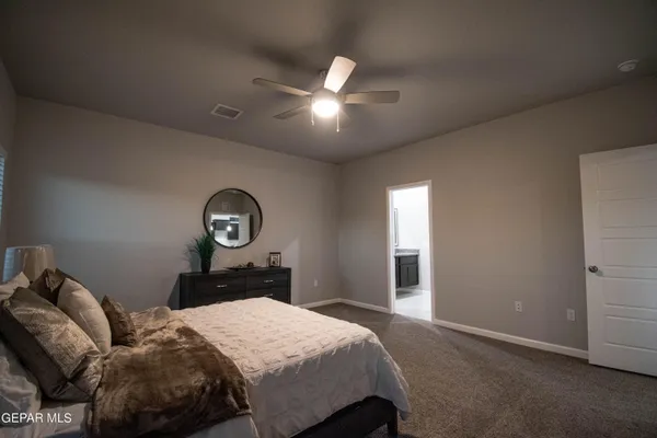 a bedroom with a bed and a lamp