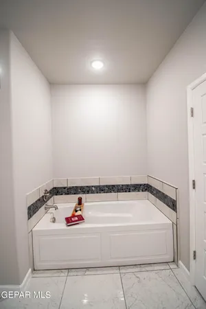 a bathroom with a bathtub and shower