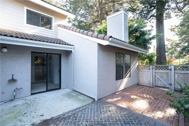 a view of a house with a backyard and trees